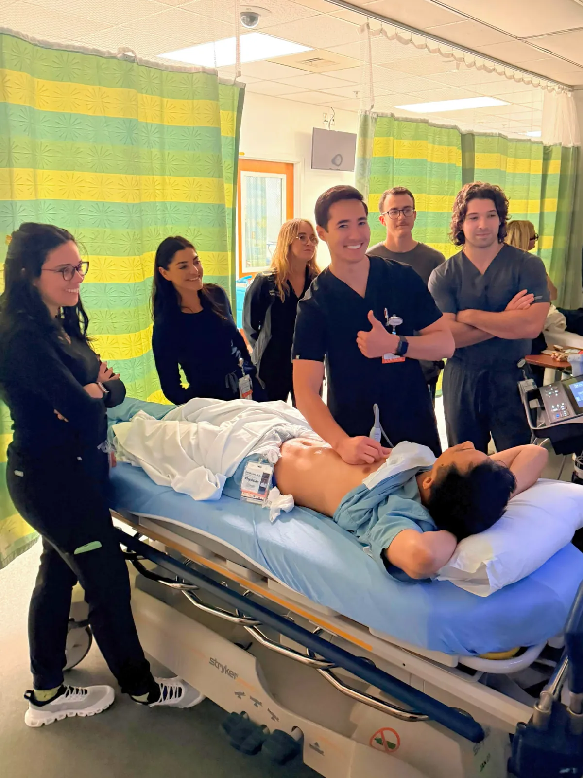 Fellows and residents gathered for a bedside ultrasound teaching session